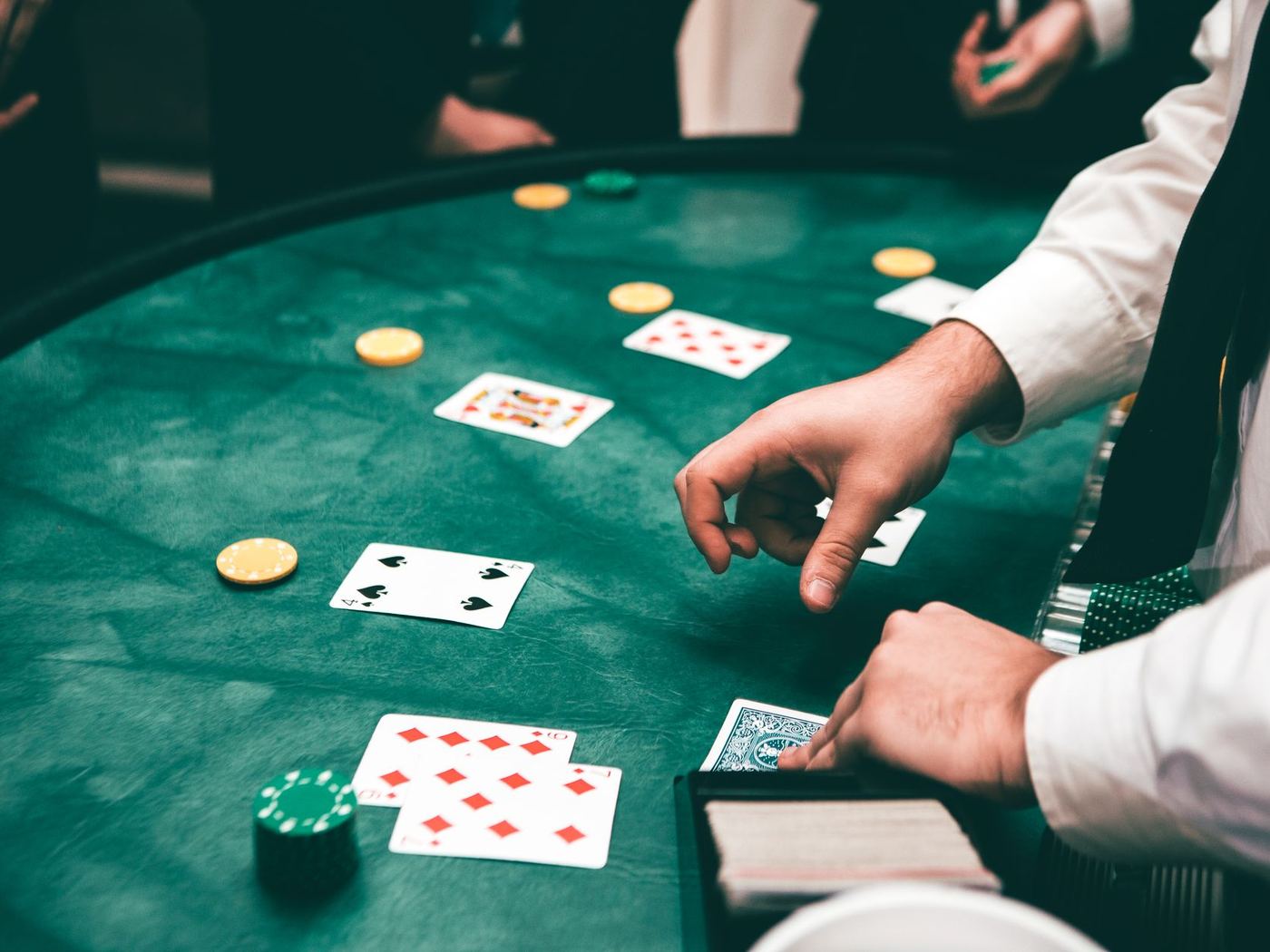 Stół do blackjacka: karty i żetony na zielonym suknie